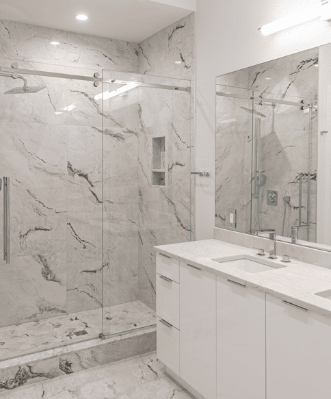 Primary bathroom with marble shower and double vanity