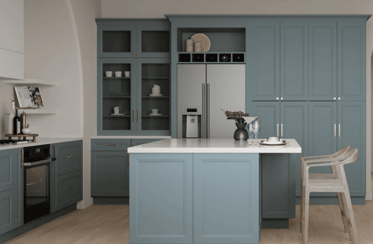 Kitchen with blue cabinetry, white waterfall island, and glass display cabinets